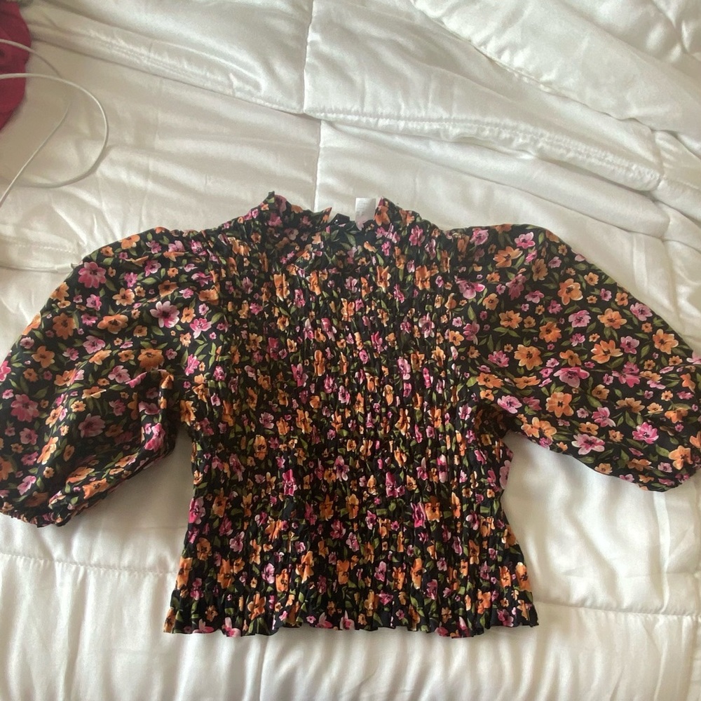 Black floral smocked blouse from H and M.